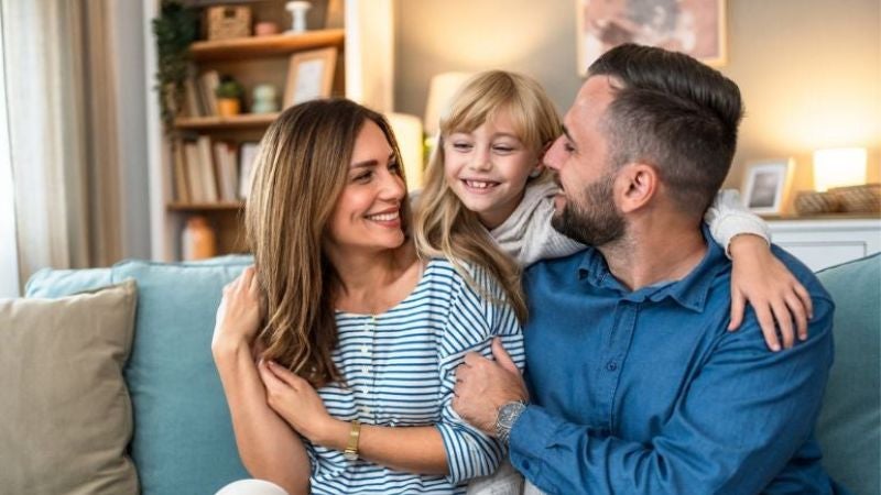 little girl with her arms around her mother and father