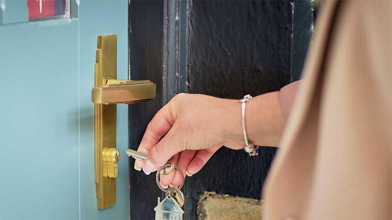 Person unlocking a door.